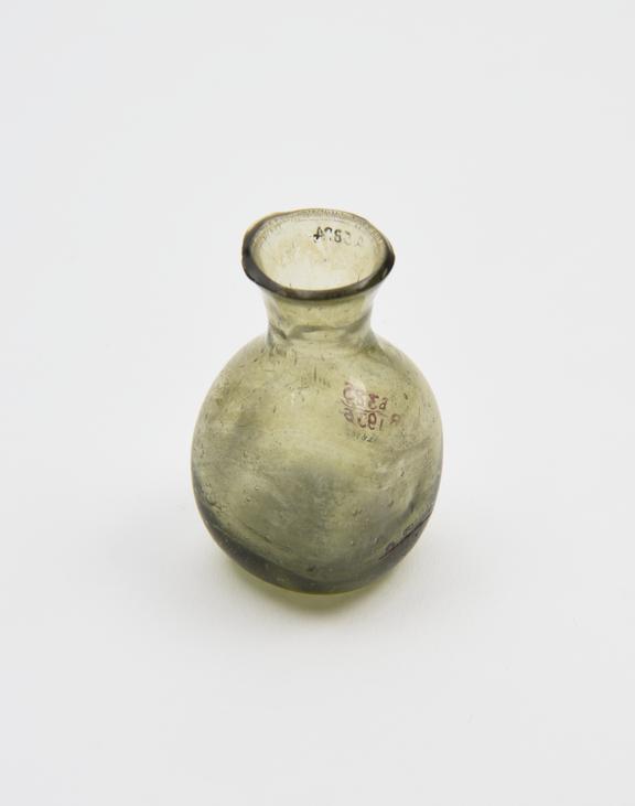 Glass bottle, green, square body, kicked base, funnel neck, rim