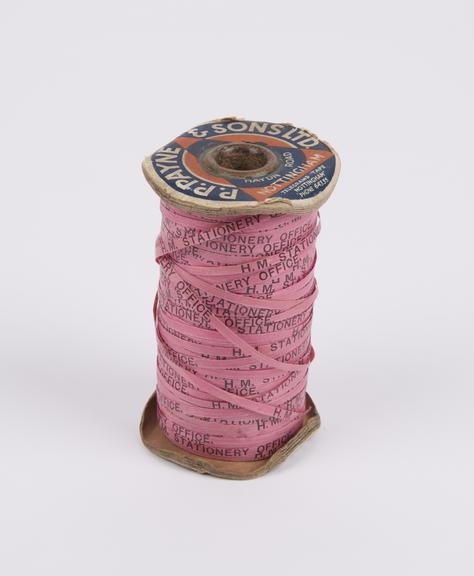 Roll of pink document tape (?red tape?), continuously marked ?H