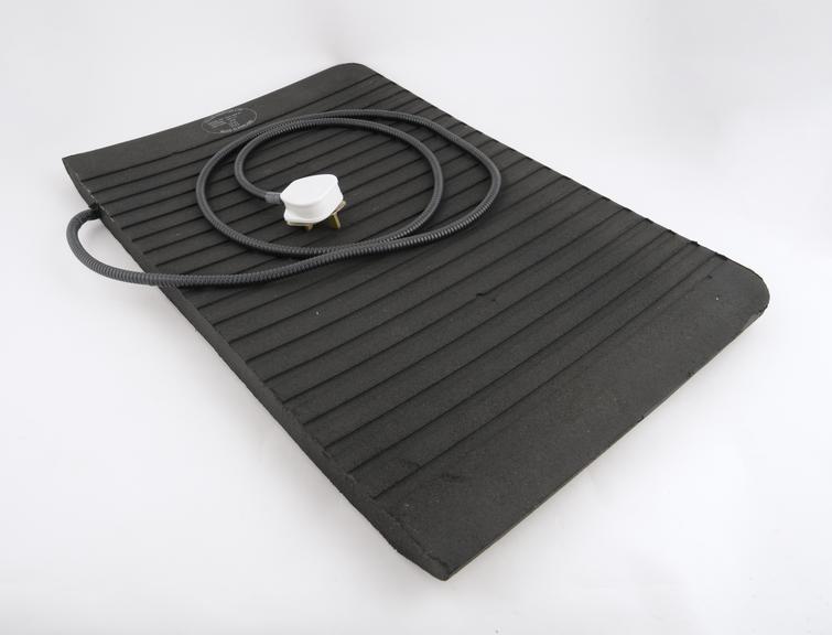 Electrically heated foot mat containing recycled rubber made by