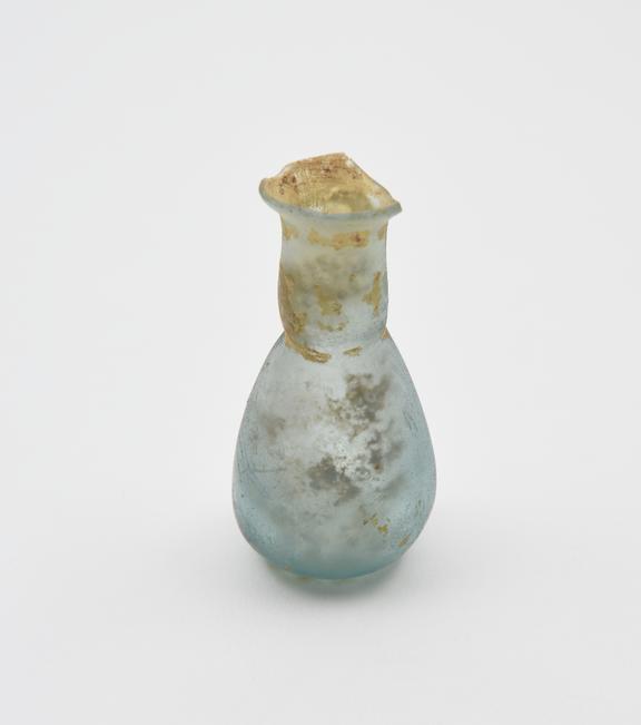 Glass flask, pale blue, conical body, flat base