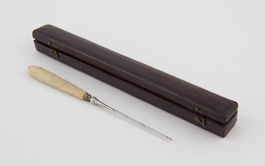 Suture needle, steel and ivory, with twine, in red leather case