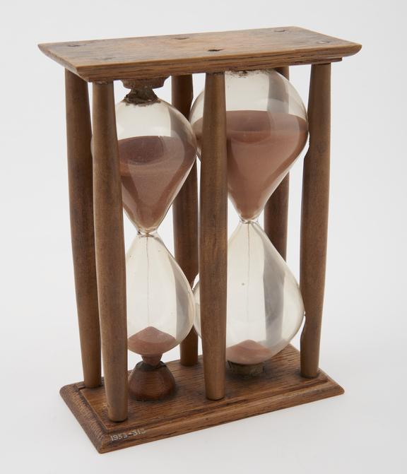 Double sand-glass in wooden mount. 29 1/2 min. and 57 min