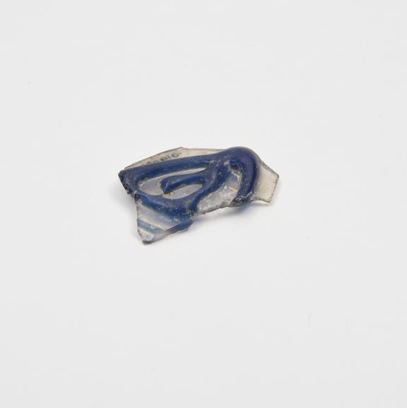 Glass sherd bearing a blue trail, possibly Roman