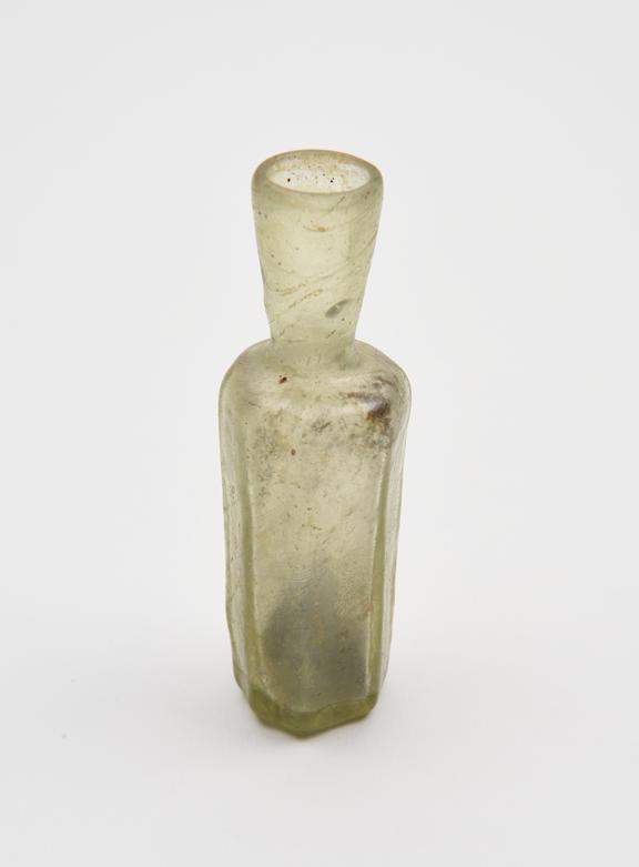 Glass flask, pale green, octagonal body tapering to flat base