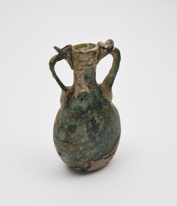 Glass bottle, green, oval body, concave base, funnel neck