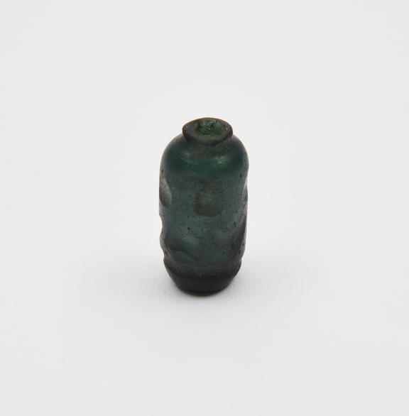 Glass bottle, deep blue, cylindrical body cut, flat base