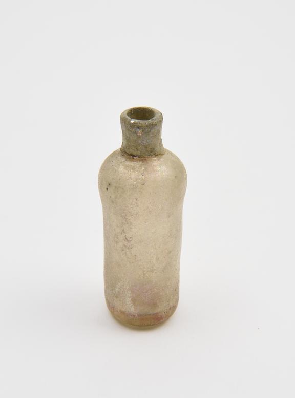 Glass bottle, pale yellow, cylindrical body, sloping shoulders