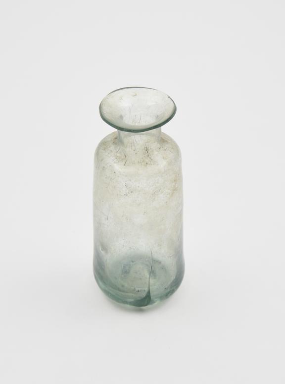 Glass bottle, green, sides tapering towards angular shoulders