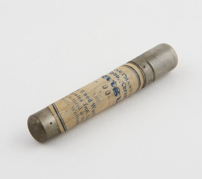 Tube of suture in metal canister, by Sanitary Wood Wool Co