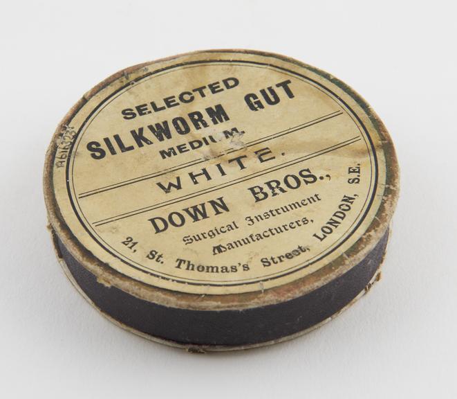 Circular cardboard container of silkworm gut, by Down Brothers