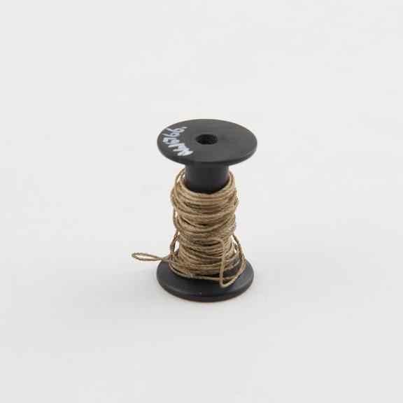 Ligature on bobbin, possibly late 19th or early 20th century