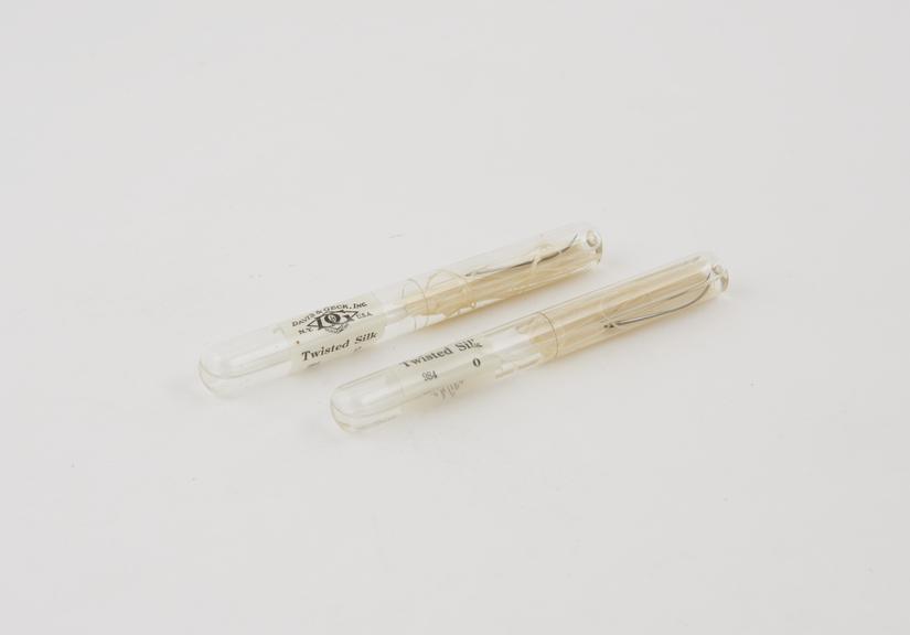 Two ampoules containing sterile silk sutures with needle