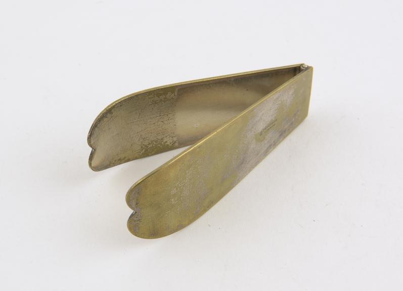 Folding tongue depressor, plated brass, made by Ferguson