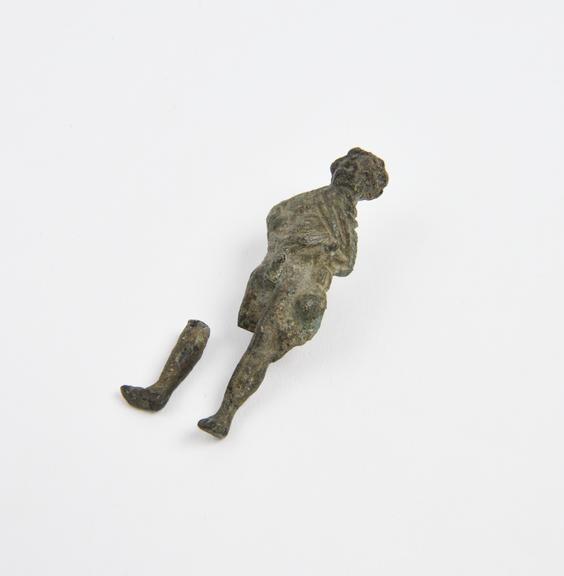 Solid amuletic bronze male figure with garments hitched up above priapic organ