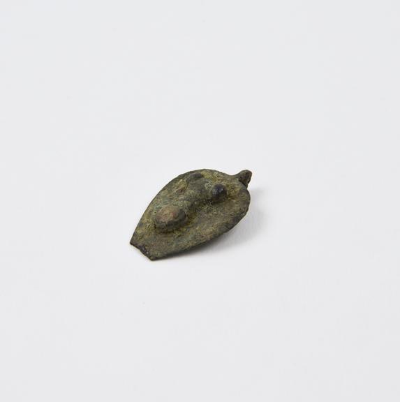 Heart-shaped bronze amulet with relief of phallus