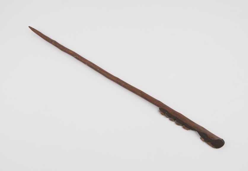 Wooden stick with pointed handle and saw blade made from flint