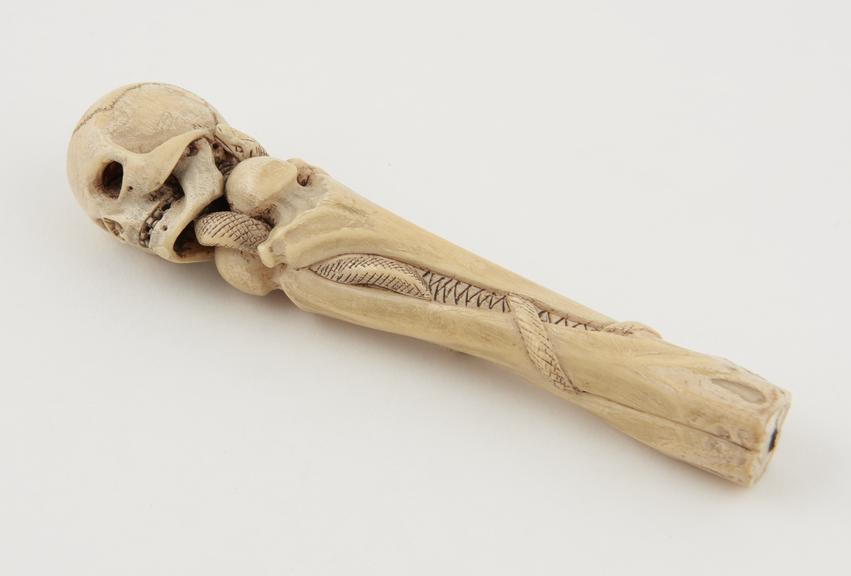 Ivory cane handle in the form of a skull mounted on three