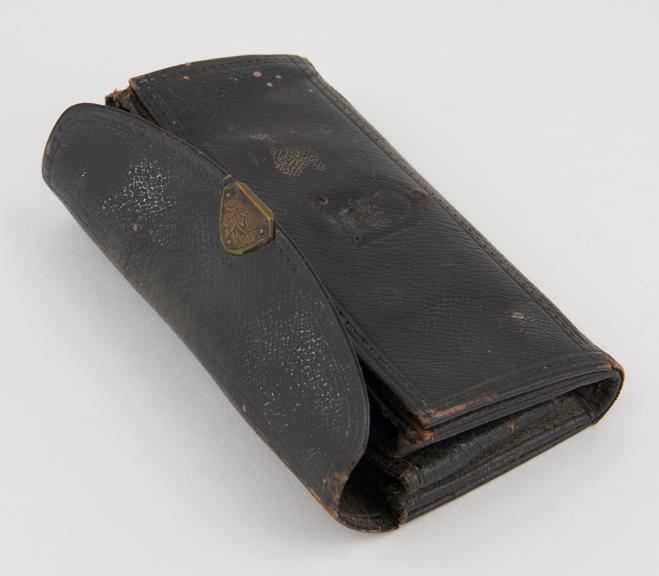 Leather roll containing chiropodial instruments, by Maw