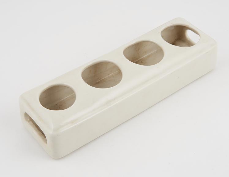 Ceramic bottle stand for four bottles, maker unknown, 1930-1960