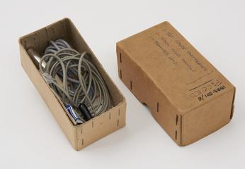 Two connecting leads (3 pin DIN plug to 3.5mm jack), spare 3 pin DIN plug, and tape spool winding handle