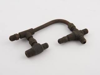 Curved metal pipe with 6 threaded ends from Locomobile Steam Car