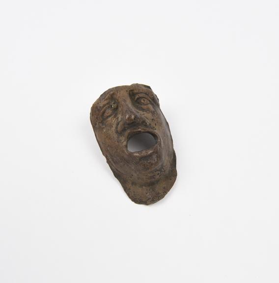 Votive face, pottery, probably Roman, 200BC-200AD