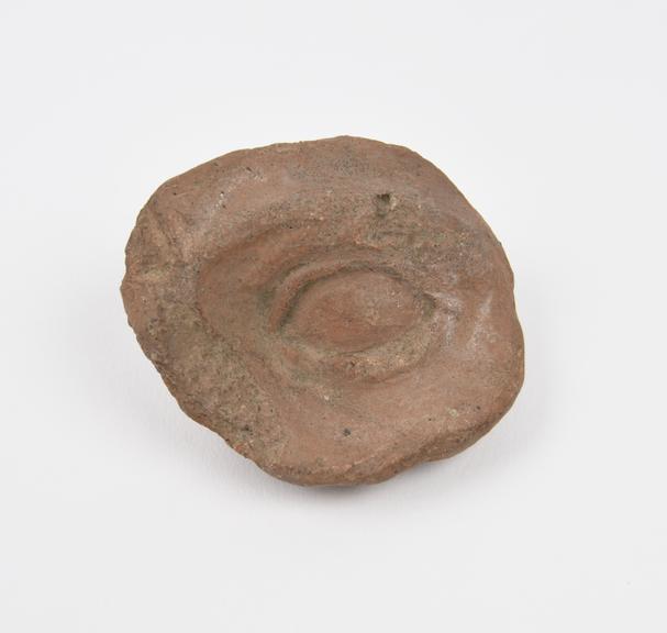 Votive left eye and surround, terracotta, Roman, 200BC-200AD