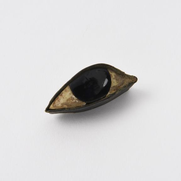 Glass and stone eye, possibly a votive offering