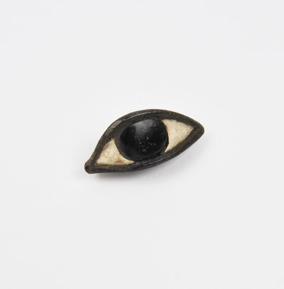 Stone metal and glass eye, possibly a votive offering