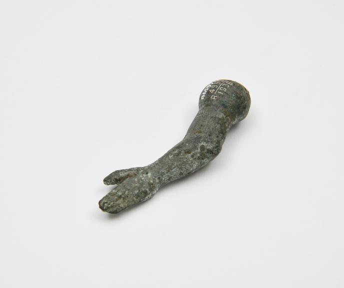 Solid (?) bronze hand and arm, votive offering, probably Roman