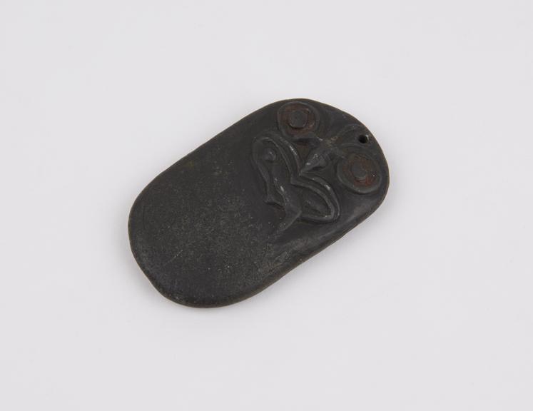 Black stone amulet, carved with a face, Maori, New Zealand