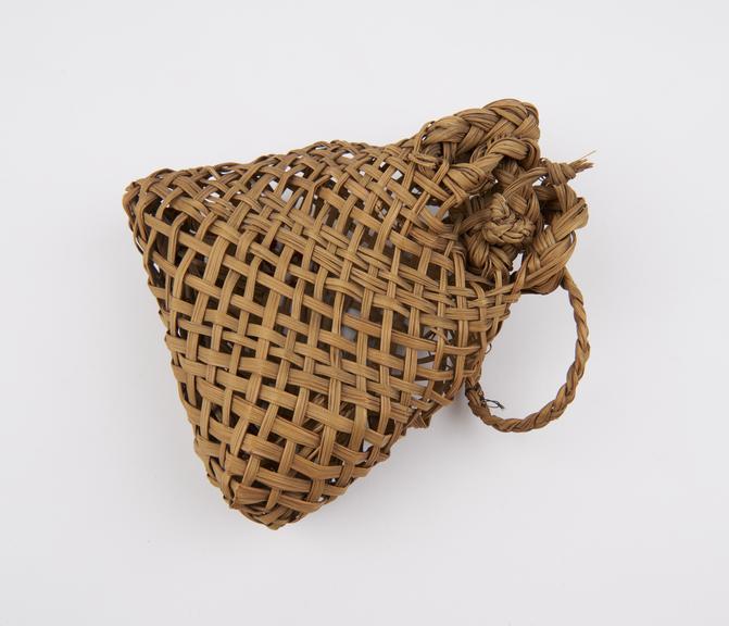 Grass fibre cooking-bag, loosely woven with plaited handle