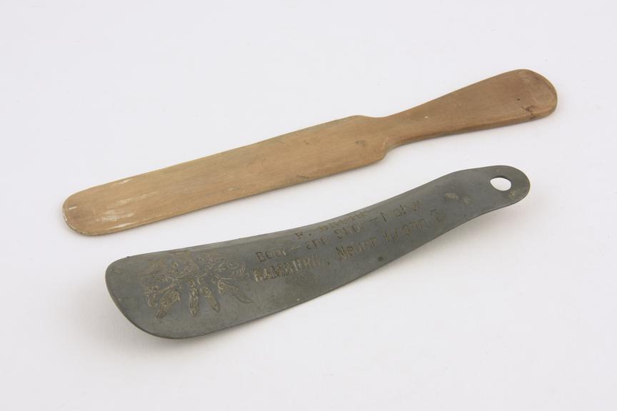 2 shoe horns, 1 wood, 1 metal, by F. Bruhn, German, 1900-1940