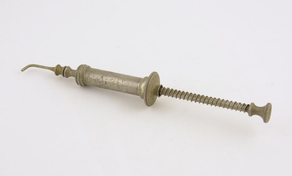 Metal syringe, with sprung plunger, by C