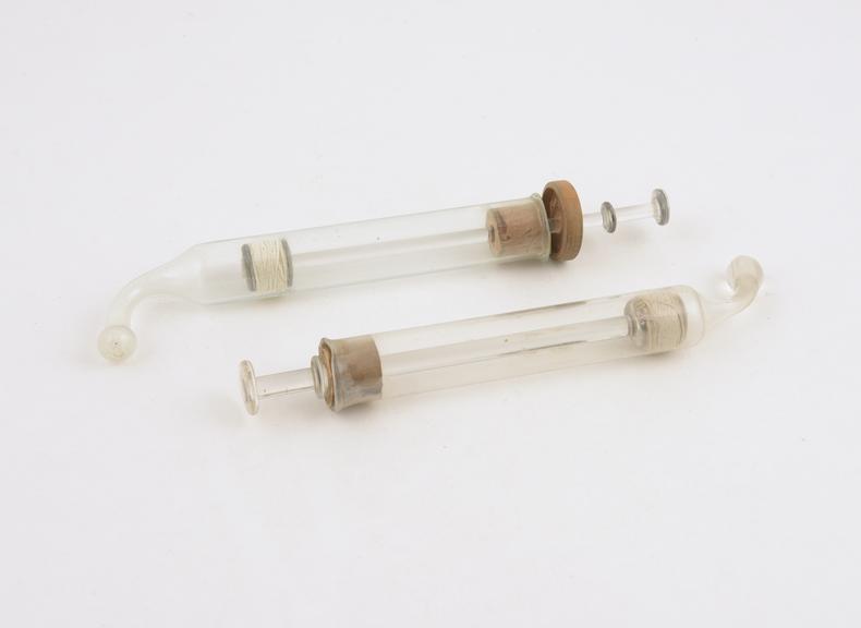 Two glass ear syringes, maker unknown, 1920-1950