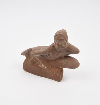 Hollow terracotta figure of Harpocrates sitting astride a huge phallus on rectangular base
