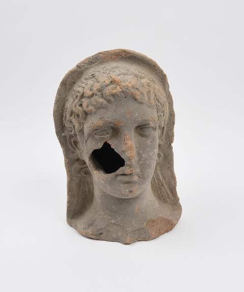 Votive female head, terracotta, Roman, 200BC-200AD