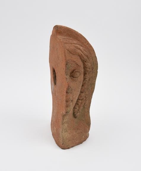 Votive female head, left profile, terracotta, hollow