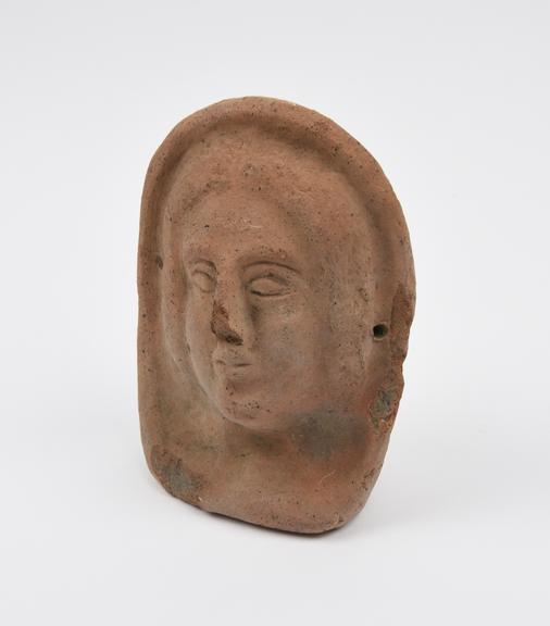 Votive female head, terracotta, hollow, probably Roman