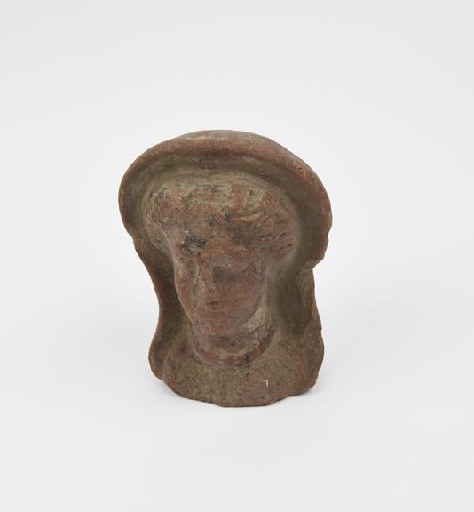 Votive female head, terracotta, hollow, probably Roman