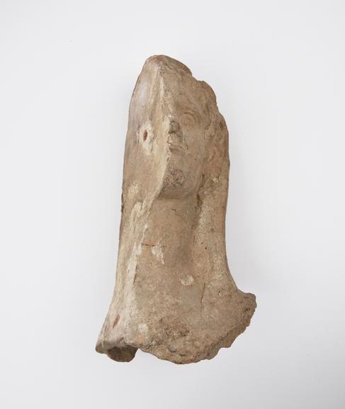 Votive left half of male(?) head, terracotta