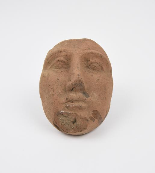 Votive face, terracotta, probably Roman, 200BC-200AD