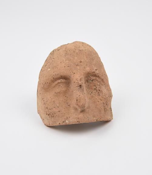 Votive mask of upper part of human face, terracotta