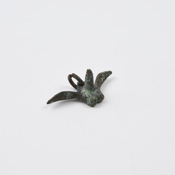 Amuletic pendant in form of winged bronze priapus, corroded