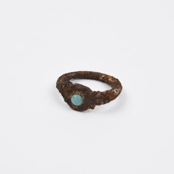 Iron finger ring, set with a turquoise, heavily encrusted