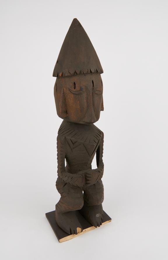 Carved wooden figure, anthropomorphic, crouching