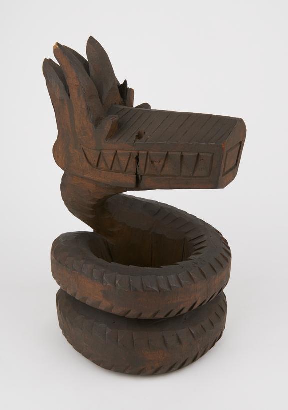 Carved wooden effigy, zoomorphic, serpent or dragon, coiled