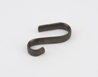 Metal S-shaped bracket associated with metal object