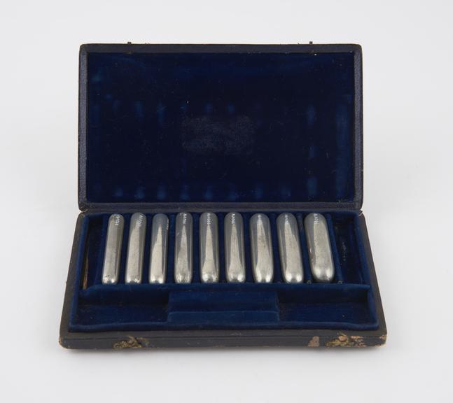 Cased set of detachable dilator or sound heads, pewter(?)