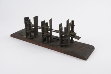 Rack and gear wheel assembly on wooden base